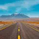 Road passing through desert towards mountains