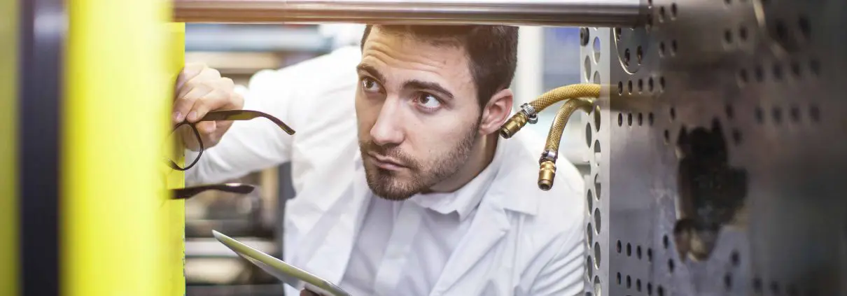 A service engineer inspecting a machine