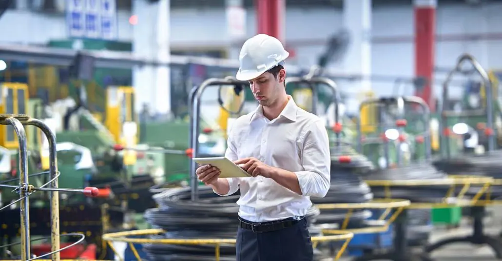 Maintenance Technician remote monitoring machinery on a tablet