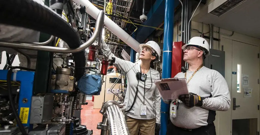 Maintenance staff inspecting a machine