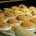 Bakery cakes on a baking tray coming out of an oven